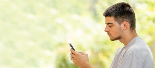 young man with mobile or cell phone outdoors