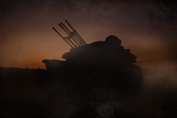 Obraz premium Silhouette of armored fighting vehicle on battlefield in night