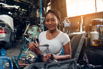 Fototapeta na wymiar Portrait of woman auto mechanic working at car repair shop with looking at camera.