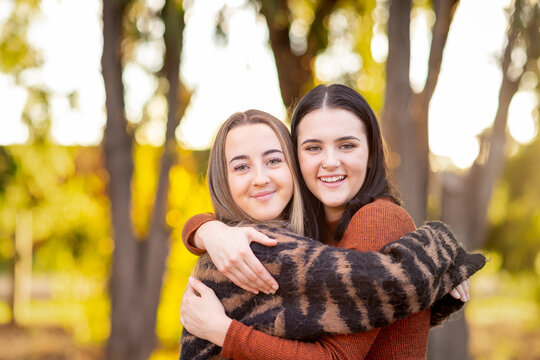 Smiling Best Friends With Arms Around Each Other