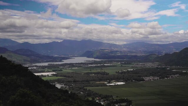 Daytime timelapse wit fast moving clouds overlooking the Amatitlan lake in guatemala city
