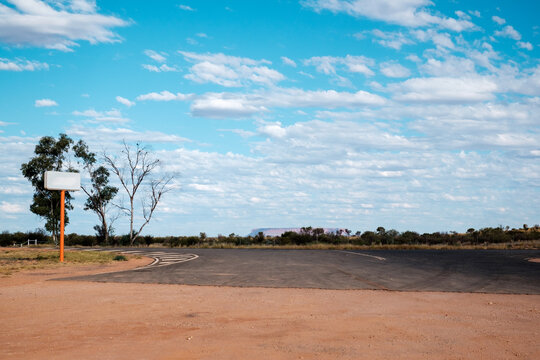 a petrol station sign at the outback with Mount Conner in the horizon