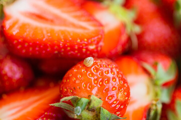 Macro photo of little snail on top of red appetizing strawberry