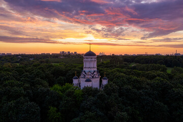 a beautiful Christian church in a park in Moscow during a picturesque summer sunset