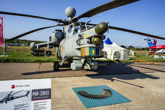 Russian attack helicopter Mi-28N "Night Hunter" (NATO-Havoc) with gun ammunition laid out in front of helicopter. Static parking MAKS-2011. Close-up. Zhukovsky, Russia - August 18, 2011