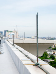 A lightning protection system is installed on the roof of a high-rise building as a bolt of...