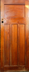 A wooden panel door is waiting to be renovated