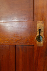 A vintage rimu wooden door has had its door furniture removed while it is being renovated