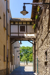 Ancient cobblestone alley with traditional spanish facade in Pamplona