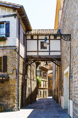 Traditional spanish street with path amid old bricked buildings in Navarre at Spain