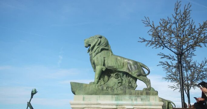 Long shot of a lion statue inside the famous "El Retiro" park in Madrid.