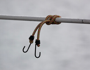 knot on a bungee rope with hooks on a boat