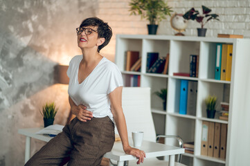 Mature short-haired woman suffering from pains in stomach