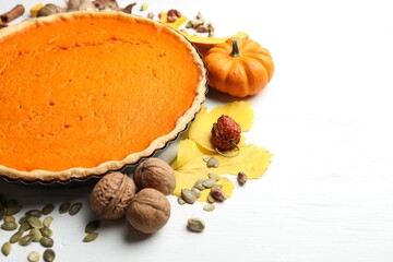 Delicious homemade pumpkin pie on white wooden table