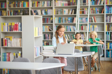 Joyous teenage girl in the reading room