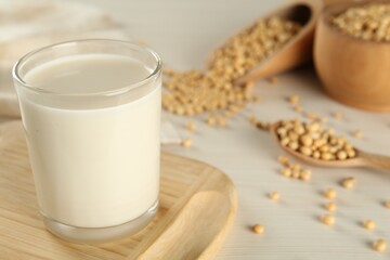 Fresh soy milk and beans on table, closeup. Space for text