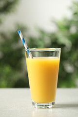 Glass of orange juice on light table