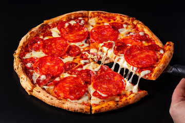 Pizza with pepperoni, sausages, cheese and ketchup