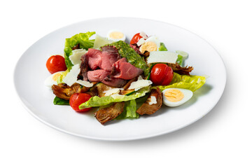 Salad with meat, pesto, tomatoes, boiled egg, lettuce, cheese and zucchini
