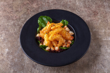 Fried shrimps with crayfish meat and salad