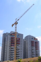 Fototapeta na wymiar Construction of a residential building. Modern architecture. Construction crane and palm tree in the foreground. ISRAEL Rishon LeZion August 2022