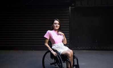 Fototapeta na wymiar Young adult woman smiling in a wheelchair