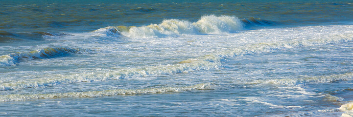 Fototapeta premium Beautiful panorama of splashing blue wave curl