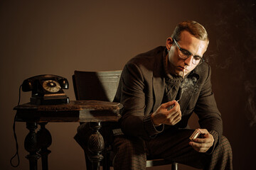 Retro style portrait of young man, writer and traveler wearing vintage style clothes isolated over dark brown background. Business, art, fashion concept