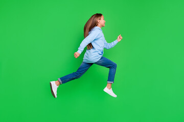 Fototapeta na wymiar Full length profile photo of small girl running marathon sport competition wear stylish blue sweatshirt isolated on green color background