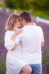 Young couple in love bride and groom, wedding day in summer. Enjoy a moment of happiness and love in a lavender field.