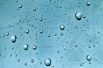 Water droplets on the inside of a plastic soda bottle photographed in close-up, a natural abstract scene