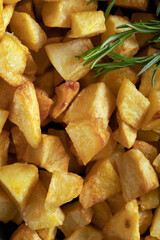 Macro close-up of homemade baked potatoes with rosemary.