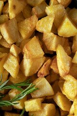 Macro close-up of homemade baked potatoes with rosemary.