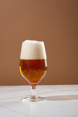 Close up of glass of light beer with foam on top  food and drink copy space
