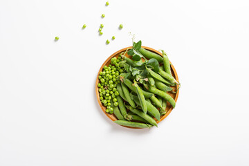 Top view of plate with green peas pods and beans