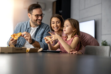 Happy lovely family eating pizza