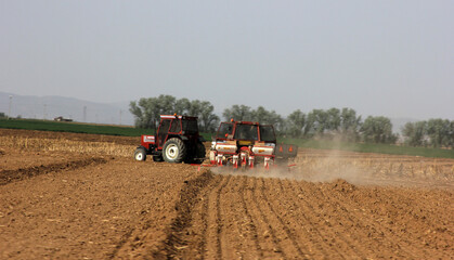Fototapeta premium Tractor of farmer plowing the field before planting.