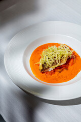 Fried fish steak in sauce with sweet potatoes and tomatoes