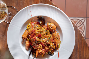 Salad with crayfish, mussels, spaghetti, cheese, tomatoes and peppers