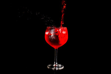 Red wine pouring into a glass sps