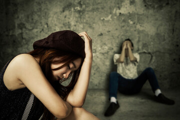 Sad young couple sitting in abandoned house