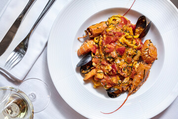 Salad with crayfish, mussels, spaghetti, cheese, tomatoes and peppers