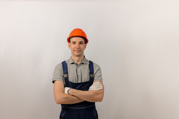 Portrait of a man builder in overalls and helmet. Copy space.