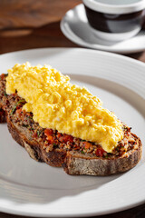 Sandwich with scrambled eggs, peppers, sprouted seeds, tomatoes