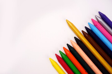 Color pencils on pink background, copy space .