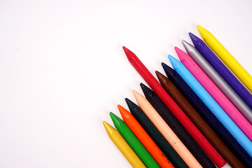 Color pencils on pink background, copy space .