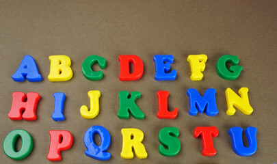 Naklejka premium Alphabet on color background. School and education concept. Empty space for text and design