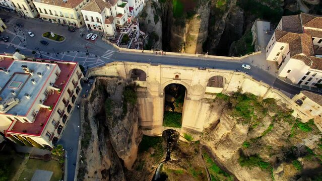 Aerial view of famous unesco heritage town Ronda and Puente Nuevo Bridge at sunset. Flying over medieval town of Ronda, Spain