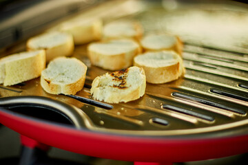 Fototapeta Prepare breakfast with bread, roasting bruschetta on the barbecue gas grill obraz