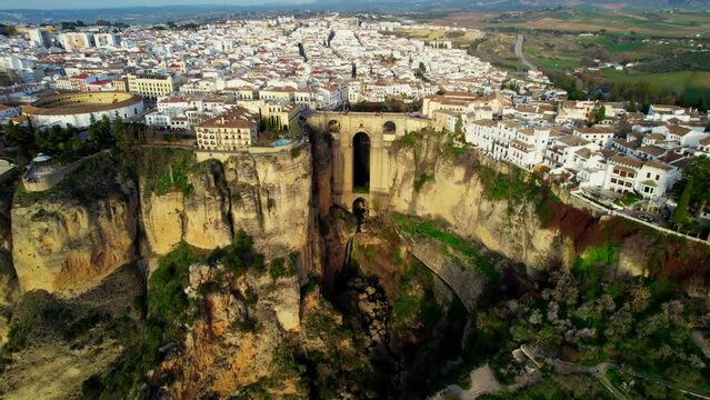Panorama of famous unesco heritage town Ronda and Puente Nuevo Bridge at sunset. Aerial view of medieval town of Ronda, Spain